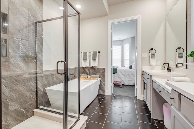 bathroom featuring tile patterned floors, vanity, and shower with separate bathtub