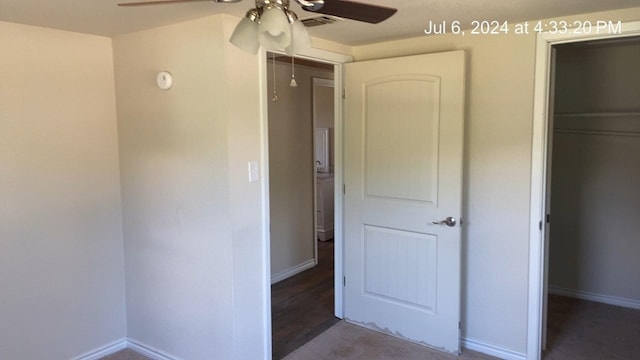 unfurnished bedroom featuring a closet, ceiling fan, and a walk in closet