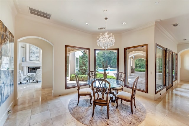 dining area with ornamental molding, light tile patterned flooring, and a chandelier