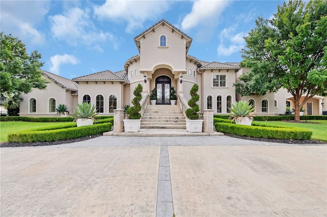 mediterranean / spanish-style home featuring french doors