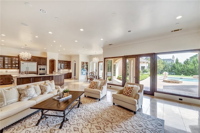 tiled living room featuring an inviting chandelier and ornamental molding