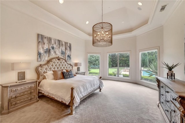 bedroom with light colored carpet, visible vents, ornamental molding, a tray ceiling, and an inviting chandelier