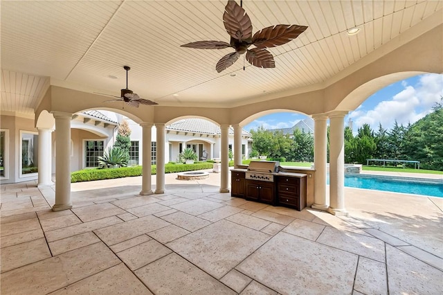 view of patio featuring exterior kitchen, an outdoor pool, and area for grilling