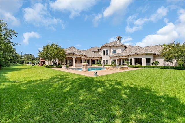 rear view of property with a patio area, a playground, and a lawn