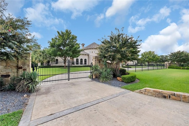 view of gate featuring a yard and fence