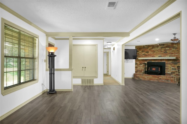 1972 Farm Rd Unit 3134, Cumby, TX 75433 - unfurnished living room featuring a textured ceiling, wood finished floors, baseboards, a brick fireplace, and ornamental molding