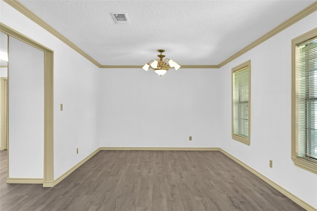 1972 Farm Rd Unit 3134, Cumby, TX 75433 - empty room featuring crown molding, a chandelier, wood finished floors, baseboards, and a textured ceiling
