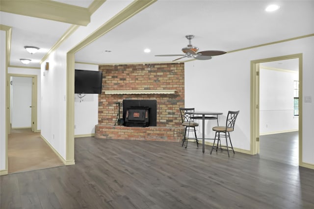 1972 Farm Rd Unit 3134, Cumby, TX 75433 - living area featuring ornamental molding, wood finished floors, a ceiling fan, a wood stove, and baseboards