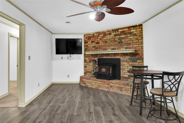 1972 Farm Rd Unit 3134, Cumby, TX 75433 - living area with wood finished floors, a wood stove, ornamental molding, ceiling fan, and baseboards