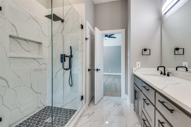 full bath with marble finish floor, ceiling fan, vanity, and a marble finish shower