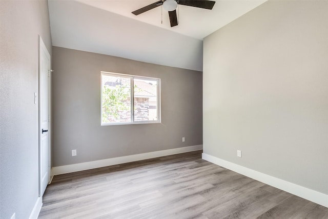 spare room with light wood finished floors, baseboards, and a ceiling fan