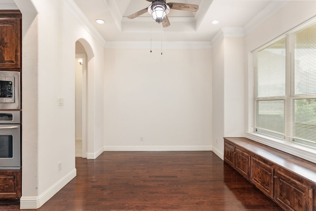 unfurnished room with ornamental molding, ceiling fan, a tray ceiling, and dark hardwood / wood-style flooring