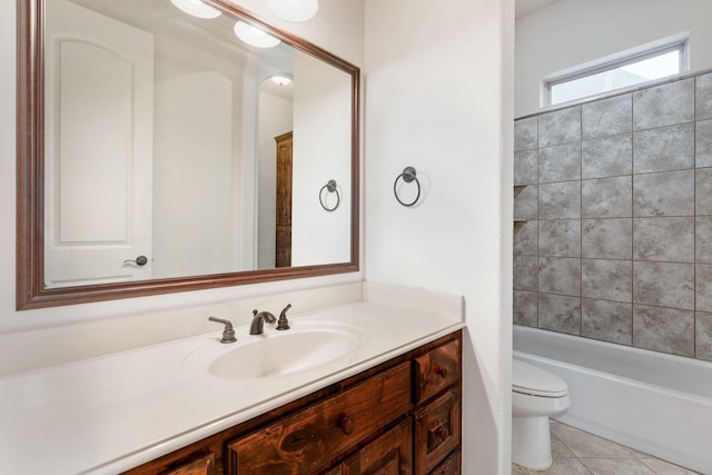 full bathroom with tiled shower / bath, tile patterned flooring, vanity, and toilet