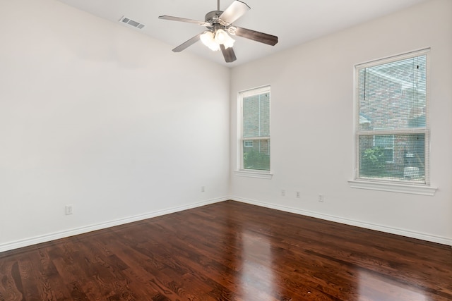 empty room with dark wood-type flooring and ceiling fan