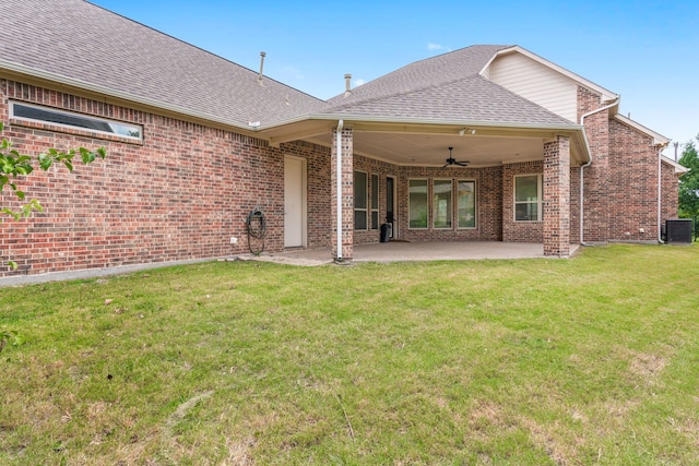 back of property featuring a lawn, a patio area, ceiling fan, and central AC unit