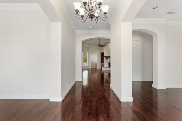 hallway featuring dark wood-type flooring, an inviting chandelier, and ornamental molding