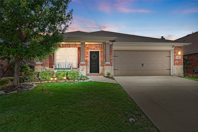 view of front facade with a garage and a yard