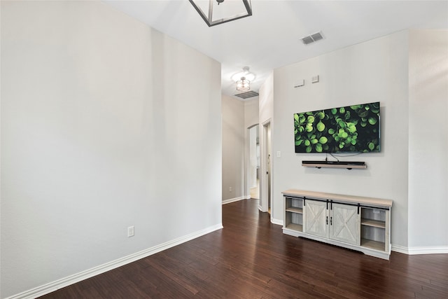 unfurnished living room with dark hardwood / wood-style floors