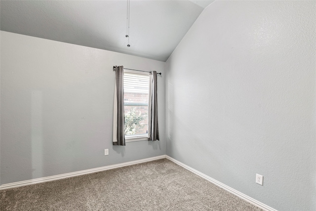 empty room featuring carpet flooring and lofted ceiling