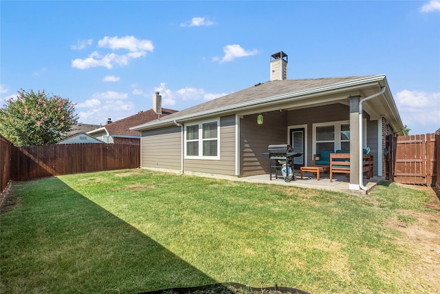 back of property with a patio and a lawn