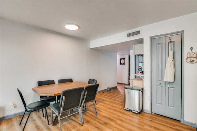 dining space with light hardwood / wood-style flooring