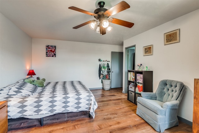 bedroom with wood-type flooring and ceiling fan