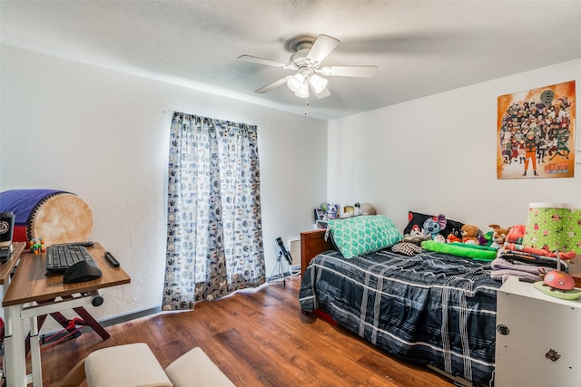 bedroom featuring hardwood / wood-style flooring and ceiling fan