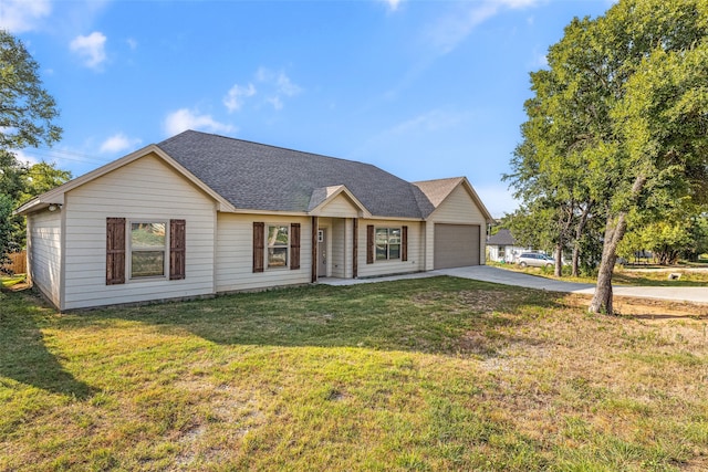 ranch-style house featuring a garage and a front lawn