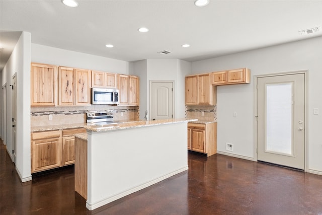 kitchen with a kitchen island with sink, tasteful backsplash, stainless steel appliances, light stone countertops, and light brown cabinets