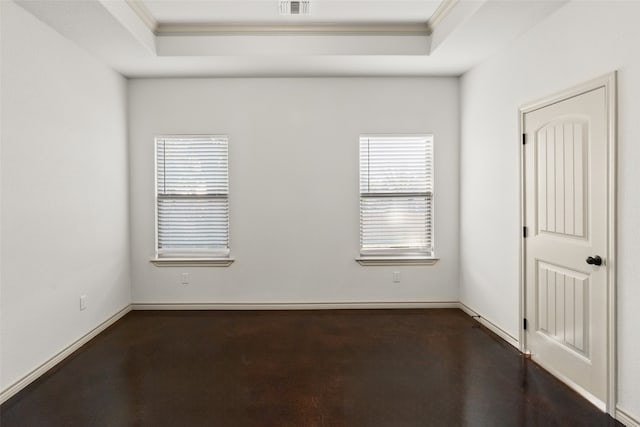 unfurnished room featuring ornamental molding and a raised ceiling