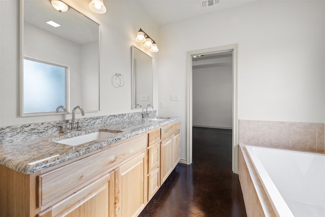 bathroom featuring vanity, hardwood / wood-style flooring, and tiled bath