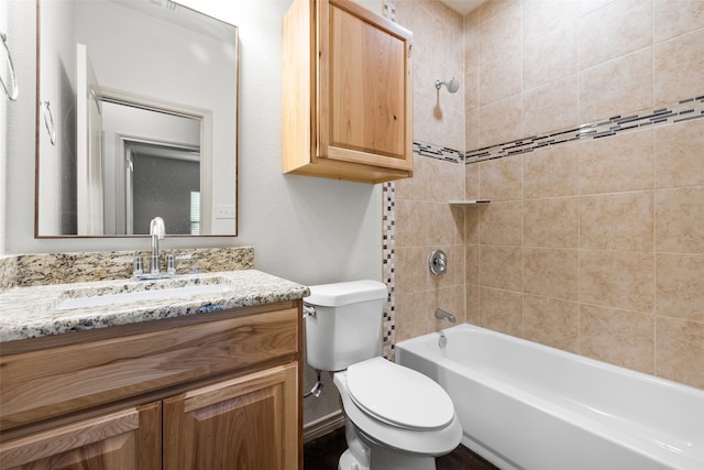 full bathroom with toilet, tiled shower / bath combo, and vanity