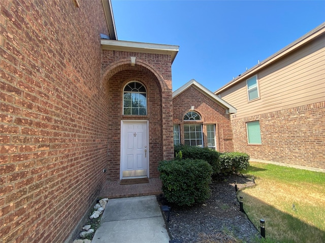 entrance to property with a yard