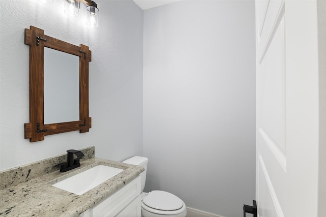 bathroom featuring toilet and vanity