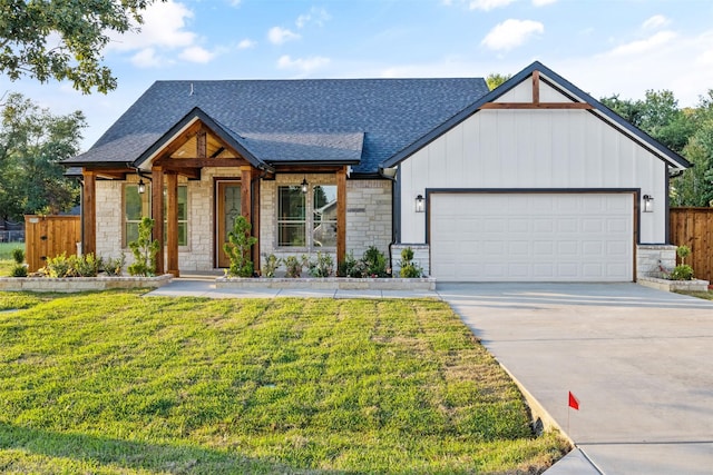 view of front of property with a front yard and a garage