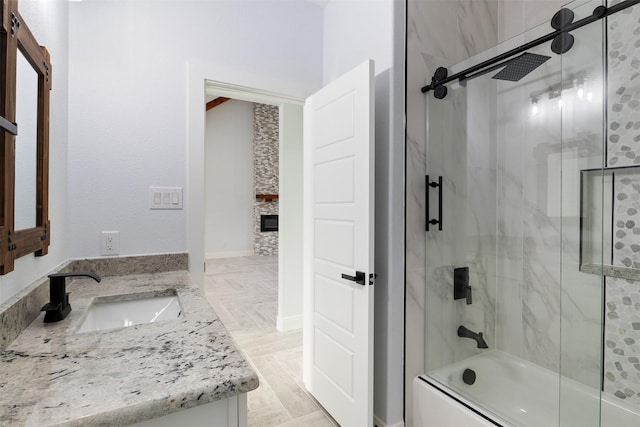 bathroom with vanity and shower / bath combination with glass door