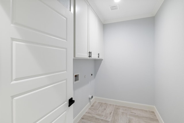 laundry area with cabinets, hookup for a gas dryer, ornamental molding, hookup for a washing machine, and hookup for an electric dryer