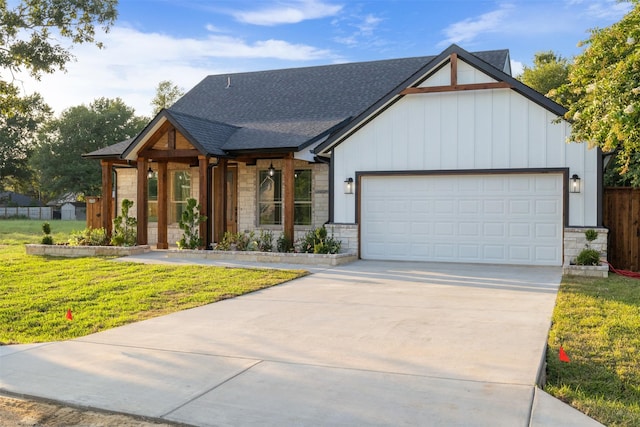 view of front of property with a front yard, a porch, and a garage