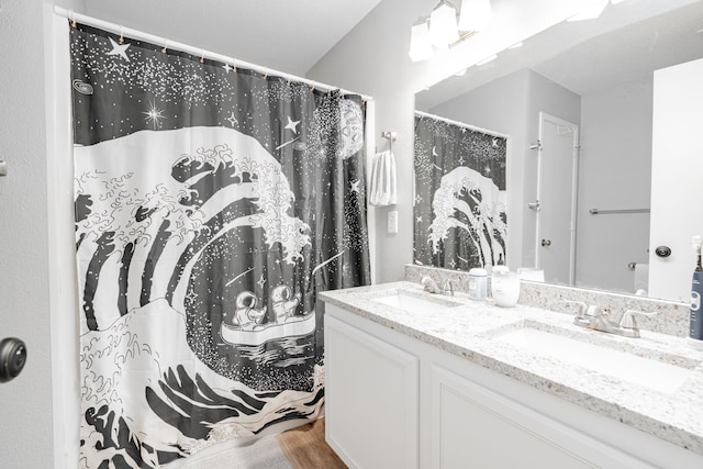 bathroom featuring hardwood / wood-style floors and double sink vanity