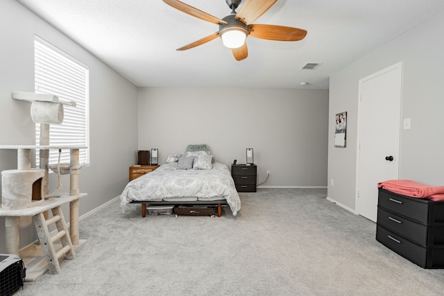 carpeted bedroom featuring multiple windows and ceiling fan