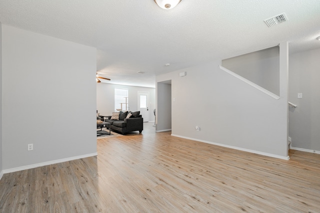 interior space with light hardwood / wood-style floors, a textured ceiling, and ceiling fan