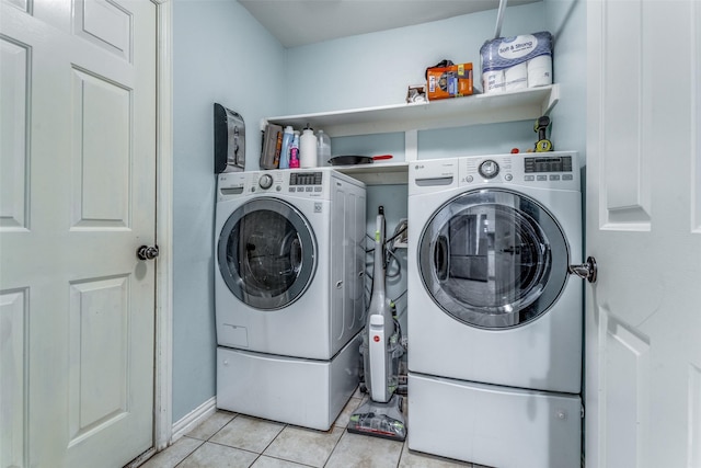 washroom featuring washer and dryer and light tile patterned flooring