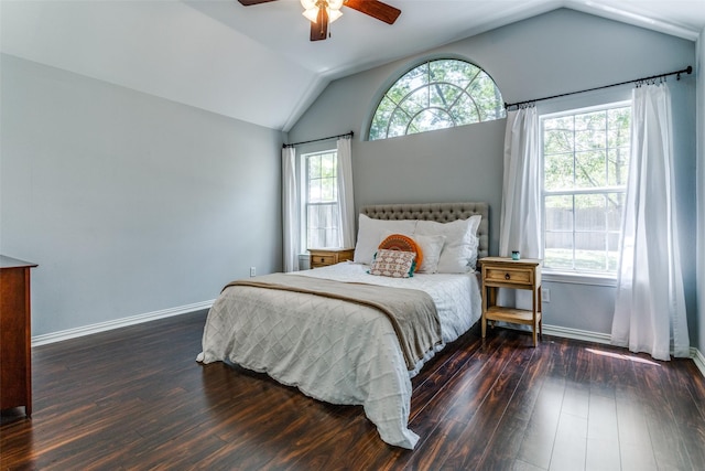 bedroom featuring ceiling fan, multiple windows, dark hardwood / wood-style flooring, and vaulted ceiling