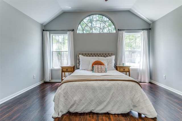 bedroom with dark wood-type flooring and lofted ceiling