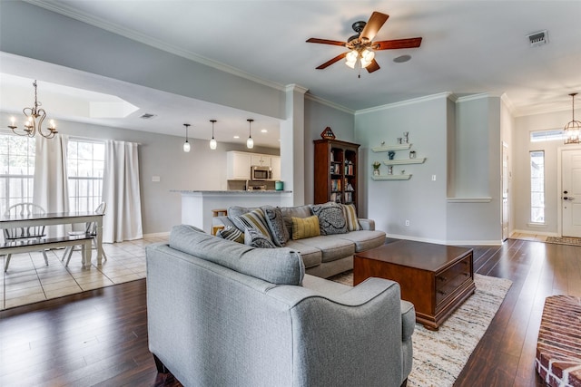 living room featuring crown molding, ceiling fan with notable chandelier, and dark hardwood / wood-style flooring