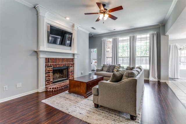 living room with a fireplace, wood-type flooring, ceiling fan, and crown molding