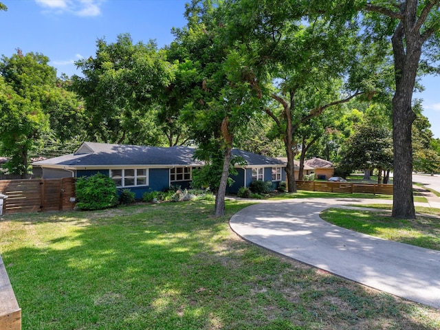 ranch-style home featuring a front yard