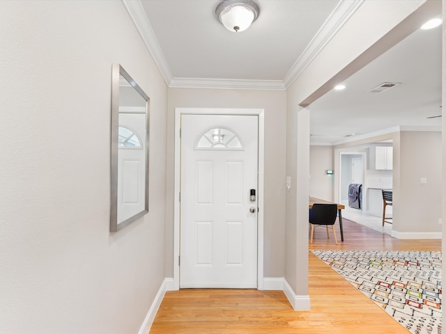 entrance foyer featuring light wood-type flooring and ornamental molding