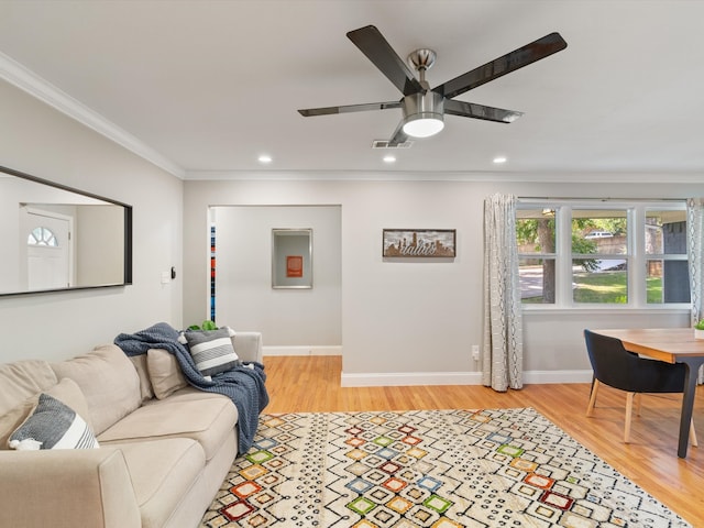 living room with crown molding, ceiling fan, and light hardwood / wood-style floors