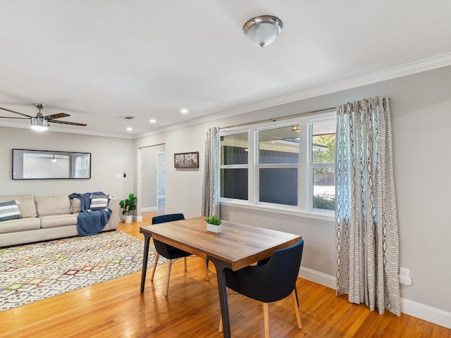 dining room featuring light wood-type flooring, ceiling fan, and ornamental molding